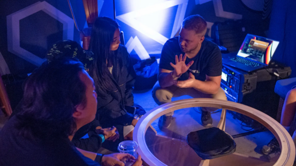 CEO of Edgesound Research Valtteri Salomaki explaining his sound technology to 3 peple in a sound studio.