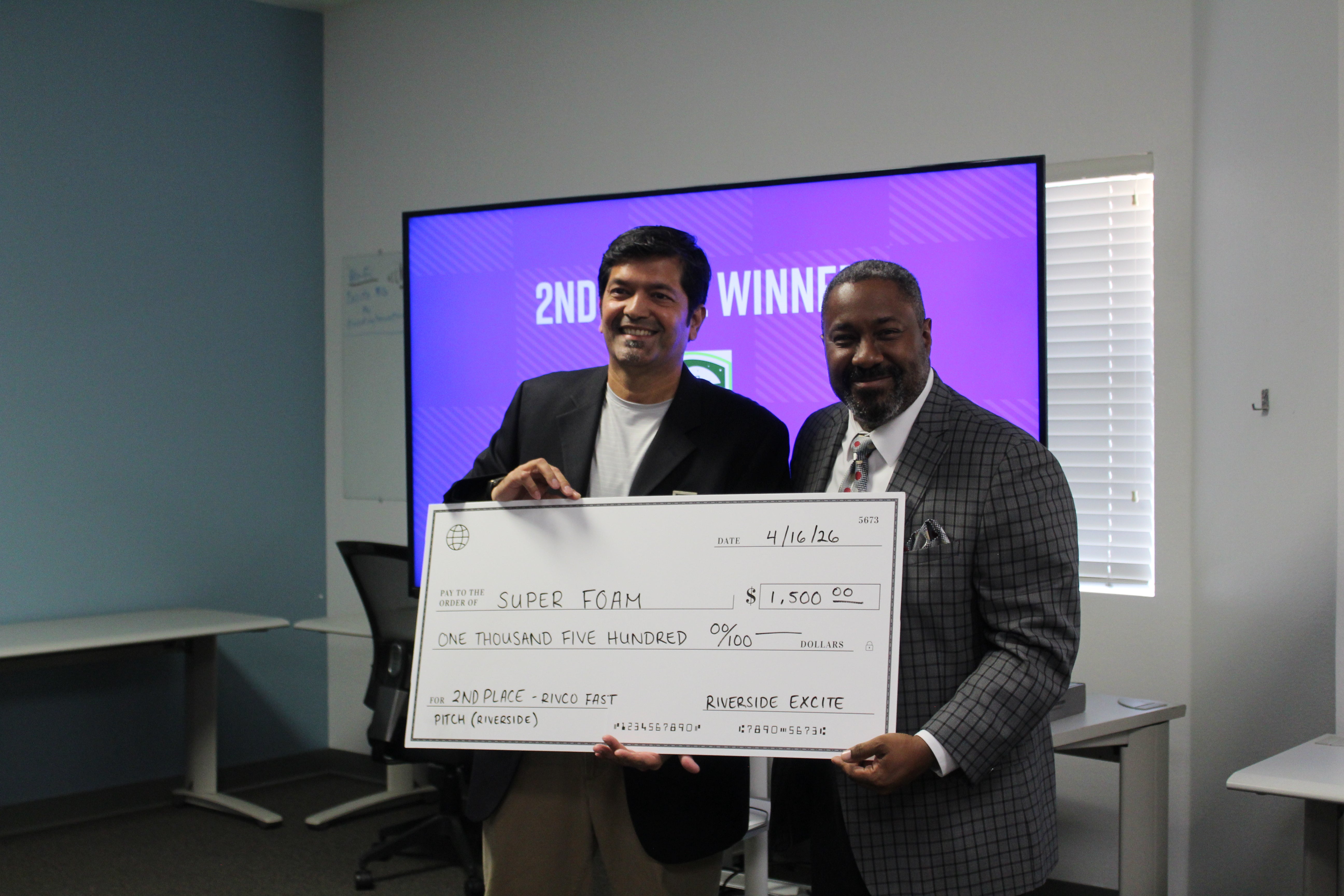 2nd Place Winner, Super Foam, represented by Zef Neemuchwala, holding a large check of $1,500 together with Tim Gramling, board member of Riverside ExCITE.