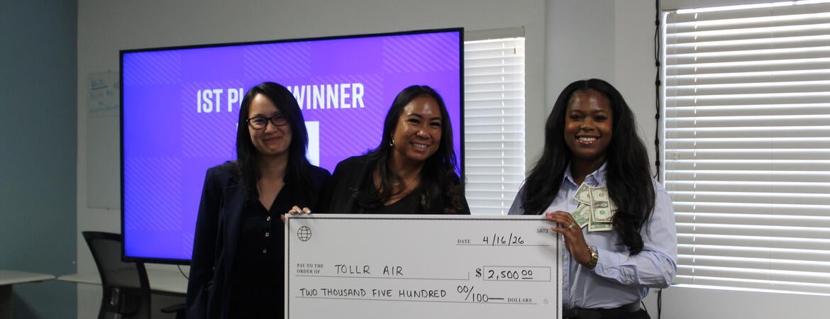 1st Place Winner of 2026 RivCo Fast Pitch Riverside Regional, Keziyah Yisrael-Gayle, representing TollR, pictured with Jennifer Yturralde of UC Riverside and Tiffany Yu of Riverside County, holding a large check of $2,500.