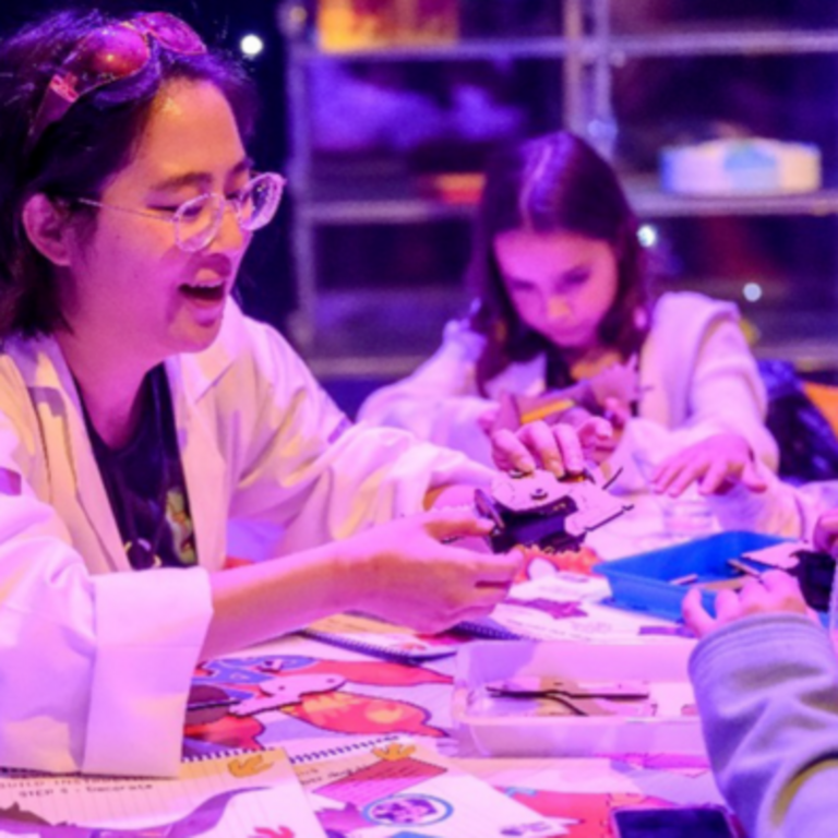 Concept Stage 1: Picture of company founder Kay from Tinker the Robot sharing her children's kits with students