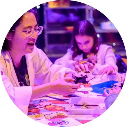 Concept Stage 1: Picture of company founder Kay from Tinker the Robot sharing her children's kits with students