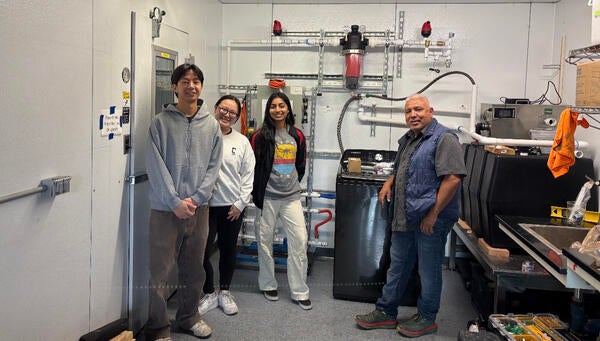 UCR engineering students worked alongside Laundry to Landscapes co-founder Miguel Cuellar to install the company's graywater filtration prototype, preparing the system for testing under real household laundry conditions.